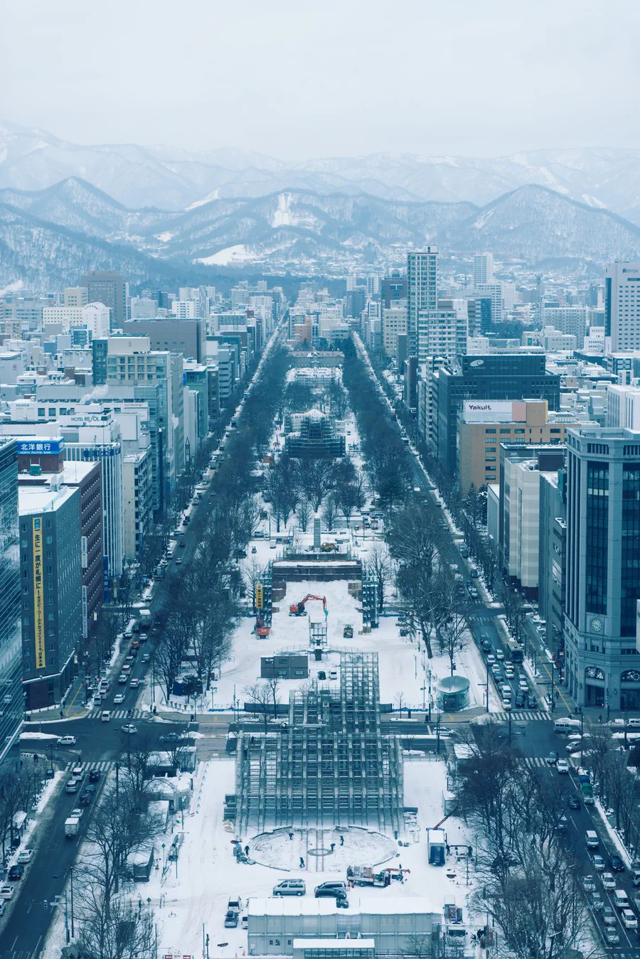Odori Park in Sapporo under snow, seen from the TV tower, with scaffolding for the snow festival going up